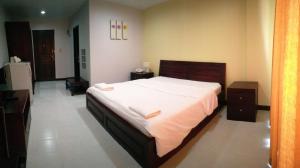 1 dormitorio con 1 cama grande con sábanas blancas en โรงแรม ศิราภา เรสซิเด้นท์ จำกัด, en Chachoengsao