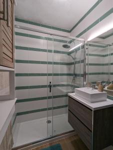 a bathroom with a shower and a sink at CoralBlu, stylish beachside flat - Fast Wi-Fi in Armação de Pêra +17 photos