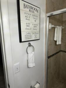 a bathroom with a shower and a towel holder at BOOK ME, 3mins Hard Rock Stadium in Miami Gardens