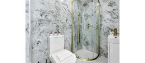 a white bathroom with a shower and a toilet at Sleek Modern 3BR Flat in Nunhead in London