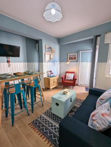 a living room with a couch and a table at CoralBlu, stylish beachside flat - Fast Wi-Fi in Armação de Pêra