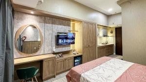 a bedroom with a bed and a mirror at Casa de Parco near ICE BSD AEON Mall - Wabi Sabi in Samporo