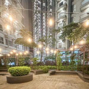 a courtyard in a city at night with lights at Casa de Parco near ICE BSD AEON Mall - Wabi Sabi in Samporo