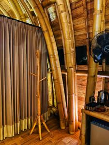 a room with a large curtain and a fan at Bamboo House - Ecobreeze in Sidemen