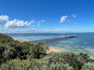 a pier in the ocean next to a beach at Tanderrum Guest Suite in Point Lonsdale