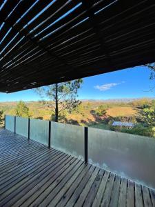 a wooden deck with a view of the mountains at CASA INTIYACO in Atos Pampa