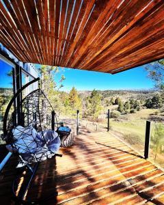 a swing on the porch of a house at CASA INTIYACO in Atos Pampa