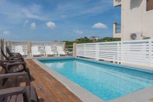 a swimming pool on top of a building at 2BR apt near restaurant, beach, nightlife & convenience store in Lance aux Épines