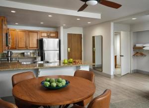 a kitchen with a table with a bowl of fruit on it at Hyatt Vacation Club at Desert Oasis in Cathedral City