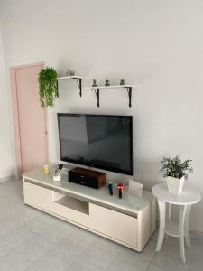 a living room with a flat screen tv on a wall at Villa 1317 D’Amour afamosa in Kampong Alor Gajah