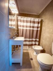 a bathroom with a sink and a toilet at Las Golondrinas Mar del Plata in Mar del Plata