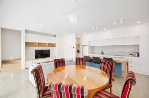 a dining room with a wooden table and chairs at Apartment G4 in Adelaide