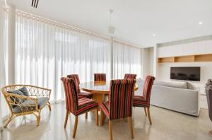 a dining room with a table and chairs and a couch at Apartment G4 in Adelaide