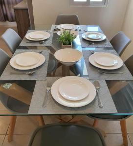a table with plates and utensils on it at Villa Izabella in Panglao Island in Dauis