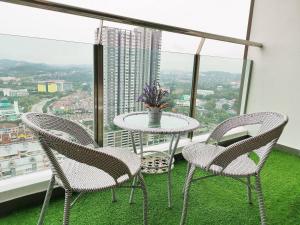 a table and chairs in a room with a window at 7INN Evo Soho Bangi (Free Parking, WIFI, Netflix) in Bandar Baru Bangi