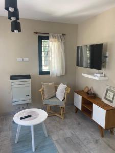 een kamer met een bureau, een stoel en een tafel bij BOSQUE LIBERTAD Casa PB in Mar Azul