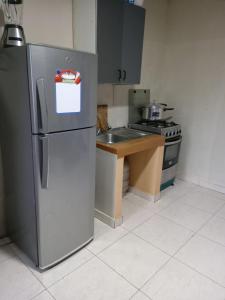 a kitchen with a stainless steel refrigerator and a sink at Alojamiento Hermanos Zambrano 204 in Cabra