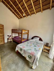 a bedroom with a bed and a chair at Pascana Casa Playa in Máncora