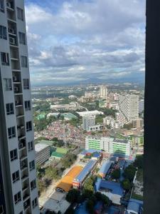 a view of a city from a tall building at A relaxing and accessible condominium unit. in Manila