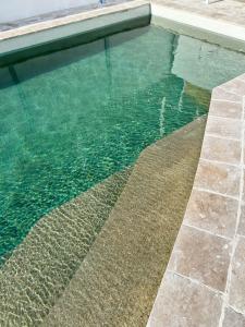 a swimming pool with clear water and a tile floor at Saltwater Apartments in Lake Cathie
