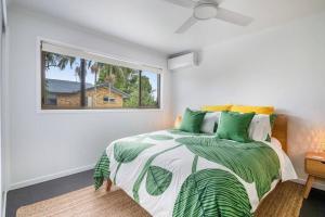 a bedroom with a bed and a window at Lennox Heaven in Lennox Head