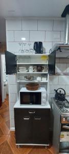 a kitchen with a stove top oven in a kitchen at cabaña los teros in Coihaique