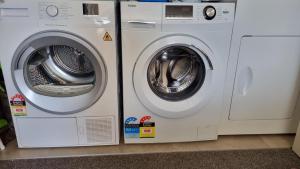 two washing machines sitting next to each other at Clarks Beach Getaway in Clarks Beach