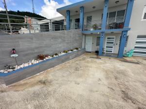 a house with a retaining wall and a patio at Ocean View in Guayama