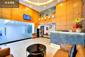 a lobby of a store with a counter and chairs at HANZ King Airport Hotel in Ho Chi Minh City