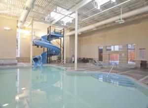 a swimming pool with a slide in a building at Parkland301 Sunlit 2,000 ft² Penthouse with Mtn View in Canmore
