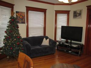 a living room with a christmas tree and a couch at Victorian Home Near Downtown in Minneapolis