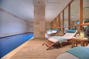een zwembad met ligstoelen en een zwembad bij Taj Luxury Suite in Kaapstad