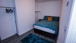 a small bedroom with a bed and a closet at Sky Rooms Modern Luxury 2 Bed Apartment in Birmingham