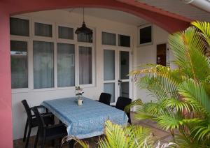a table on the back porch of a house at Vythee Residence in Chemin Grenier