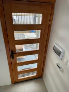 a wooden door with a window in a room at Departamento manantiales 1 in Punta Arenas