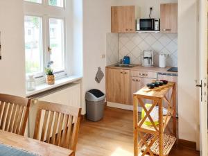a small kitchen with a table and a microwave at Holiday apartment in the Mecklenburg Lake District in Buchholz