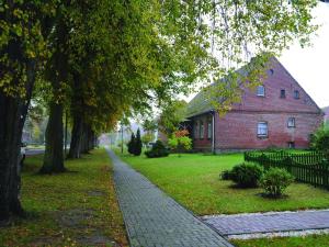 a cobblestone sidewalk in front of a brick building at Holiday apartment in the Mecklenburg Lake District in Buchholz