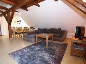 a living room with a couch and a table at Studio in Buchholz on Lake Müritz in Buchholz