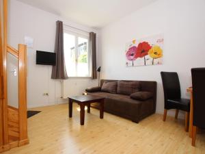 a living room with a couch and a table at Terraced house with WiFi in Buchholz