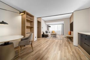 a kitchen and living room with a table and chairs at Sheraton Chengdu Lido Hotel in Chengdu +87 photos