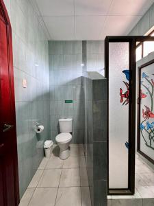 a bathroom with a toilet and a shower stall at GRAND SUN'S HOUSE in Puerto Baquerizo Moreno