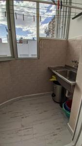 a bathroom with a sink and a window at Departamento Plaza Colon in Mar del Plata