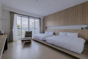 En eller flere senger på et rom på Terumahouse 照間