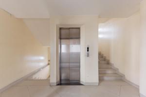 a hallway with a elevator in a building with stairs at RedDoorz @ Malabar Street in Bandung