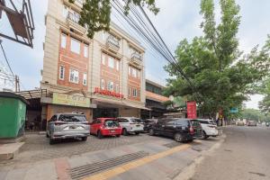 a group of cars parked in front of a building at RedDoorz @ Malabar Street in Bandung