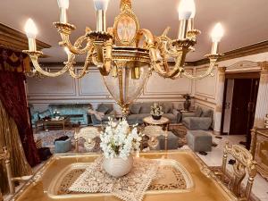 a large living room with a large chandelier at LuXury Apartment Nasr City - CityStars in Cairo