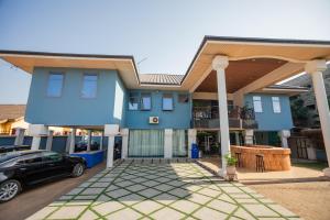 a house with a car parked in front of it at Beauty Hotel in Accra