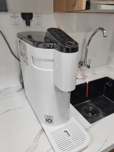 a white food processor sitting on a kitchen counter at ORPHIC Homestay @ Bandar Country Homes, Rawang in Rawang +11 photos
