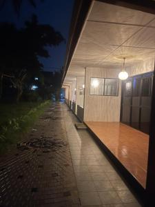 a building with a light on the side of it at night at River View Banquet & Resort in Wadduwa