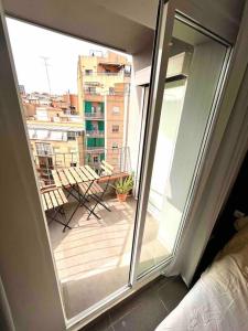 a view of a balcony from a room with a window at Apartamentos con baño privado frente al metro L5 Barcelona-Hospitalet in Hospitalet de Llobregat